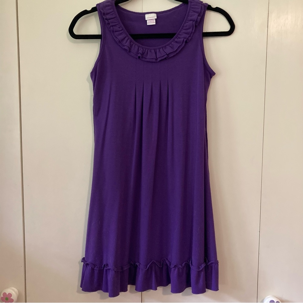 Purple tank dress with ruffle at neck and bottom.
